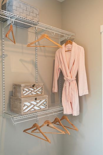 A rack with a robe and shoes